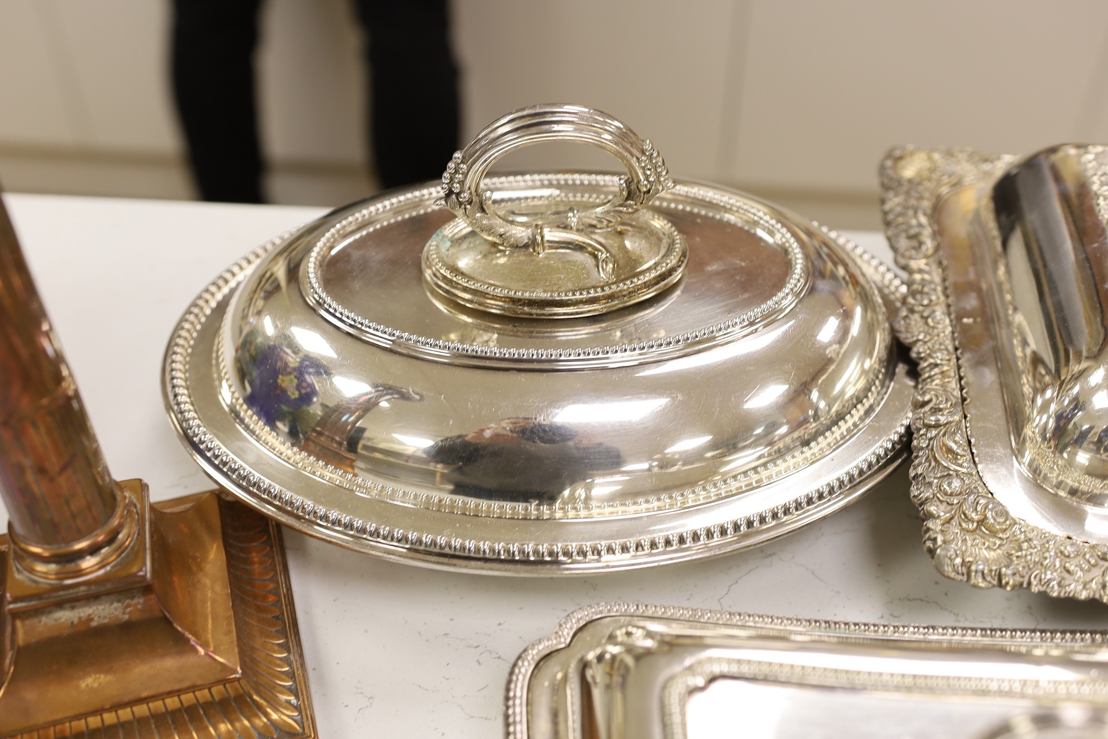 Three silver plated entrée dishes, a pair of candlesticks and a carving knife and fork, largest dish, 32 cms wide